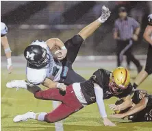  ?? STAFF PHOTO BY STUART CAHILL ?? SHOULDER THE LOAD: Marshfield’s Casey Phinney (24) is bowled over by BC High cornerback Luke Murphy during last night’s nonleague game in Dorchester.