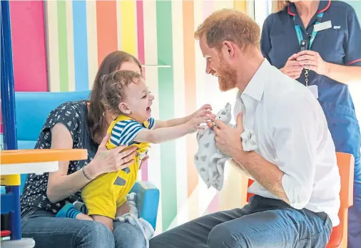  ??  ?? GIGGLES: The Duke of Sussex plays with Noah Nicholson during his visit to Sheffield Children’s Hospital, where he opened the new wing