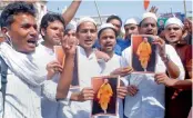  ?? — PTI ?? Muslim supporters of the BJP hold posters of Yogi Adityanath to celebrate his elevation as the chief minister in Allahabad on Tuesday.