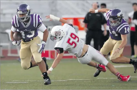  ?? Katharine Lotze/The Signal (See additional photos on signalscv.com) ?? (Above) Valencia’s Moises Haynes (43) dodges a tackle by Chaparral’s Jaxon Richards (59) during a football game against Chaparral of Scottsdale, Ariz. on Friday. (Below, right) Valencia’s Jayvaun Wilson (6) heads for the end zone for a touchdown on...