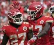  ?? ED ZURGA — THE ASSOCIATED PRESS ?? Chiefs running back Kareem Hunt (27) is congratula­ted by wide receiver Chris Conley (17) after scoring a touchdown against the Eagles during the second half on Sept. 17 in Kansas City, Mo.
