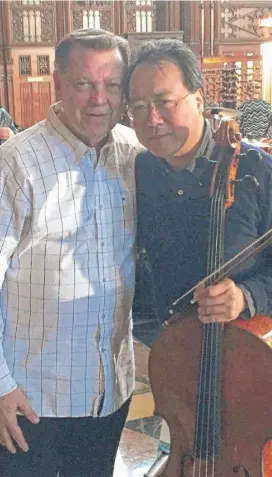 ??  ?? Yo- Yo Ma visited with Rev. Michael Pfleger and gave a performanc­e at St. Sabina.