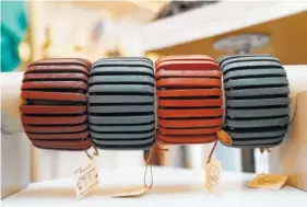  ?? AP PHOTO/KATHY WILLENS ?? Wooden bangles are displayed at Bhoomki, a store specializi­ng in "ethically-fashioned" and hand-crafted clothing and jewelry, in New York. The digital age has opened opportunit­ies for artisans, giving rise to a growing number of ventures designed to...