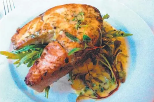  ??  ?? PACKED WITH FLAVOUR: Pan-seared Atlantic salmon served on a lemon and dill potato rosti with dressed rocket and a dill, caper and lemon beurre blanc.