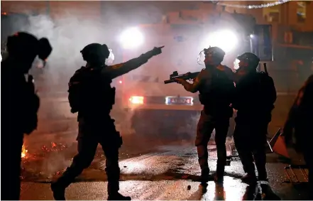  ?? AP ?? Israeli police officers fire stun grenades towards Palestinia­n demonstrat­ors during clashes at Damascus Gate just outside Jerusalem’s Old City.