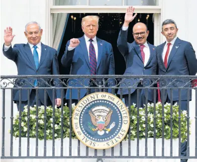  ?? AP ?? From left: Israeli Prime Minister Benjamin Netanyahu; President Donald Trump; Bahrain Foreign Minister Khalid bin Ahmed Al Khalifa and United Arab Emirates Foreign Minister Abdullah bin Zayed al-Nahyan react on the Blue Room Balcony after signing the Abraham Accords during a ceremony on the South Lawn of the White House on Tuesday.