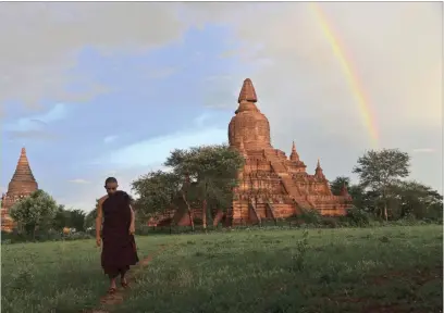  ?? PICTURE: EPA ?? A monk walks through a field near a damaged temple in Bagan, south-west of Mandalay, Myanmar. A powerful 6.8 magnitude earthquake hit central Myanmar, causing three deaths and damage to several temples in the ancient city of Bagan and some parts of...