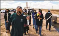  ?? ARIANA DREHSLER THE NEW YORK TIMES ?? Enrique Morones (center), a San Diegan who heads the group Gente Unida, and other mourners attend a vigil for the 13 undocument­ed migrants who died in last month’s vehicle crash.