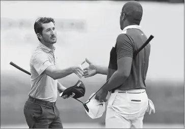  ?? CHARLIE NEIBERGALL/AP PHOTO ?? Andrew Landry, left, shakes hands with Jhonattan Vegas after putting on the 18th green during the third round of the John Deere Classic on Saturday at TPC Deere Run in Silvis, Ill.