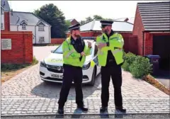  ?? CHRIS J RADCLIFF/AFP ?? Police officers are seen standing guard outside a residentia­l address in Amesbury, southern England, on Thursday.