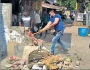  ?? SUSHIL KUMAR/HT PHOTO/SOURCED ?? North Corporatio­n officials (top) during the antiencroa­chment drive at Khari Baoli on Monday. An official demolishes a wall in Subhash Nagar in west Delhi.