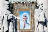  ??  ?? A file picture dated October 19, 2003 shows a portrait of Mother Teresa on the façade of the St Peter’s Basilica at the Vatican.