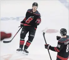  ?? GERRY BROOME THE ASSOCIATED PRESS ?? Carolina Hurricanes’ Sebastian Aho, back, is congratula­ted by Teuvo Teravainen after his hat trick against the Nashville Predators on Sunday.