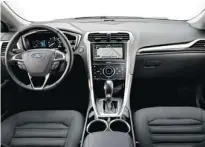  ??  ?? The Fusion SE Hybrid’s interior is roomy and impressive­ly quiet.