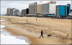  ?? STEVE HELBER/AP ?? Like many other U.S. beaches, the usually bustling Virginia Beach oceanfront sits quiet and empty April 4.