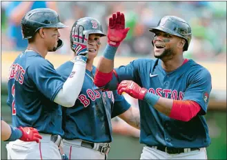  ?? D. ROSS CAMERON/AP PHOTO ?? Boston Red Sox’s Franchy Cordero, right is greeted by teammates Xander Bogaerts (2) and Rafael Devers after hitting a three-run home run off Oakland Athletics starting pitcher Frankie Montas during Sunday’s game in Oakland, Calif.