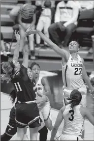  ?? AP/JESSICA HILL ?? (11) shoots as Connecticu­t’s Azura Stevens (23) defends during Connecticu­t’s 75-21 victory over Cincinnati. Connecticu­t will play South Florida in the championsh­ip game of the American Athletic Conference Tournament.