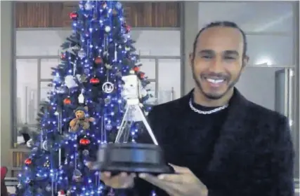  ??  ?? Lewis Hamilton with the BBC Sports Personalit­y of the Year trophy