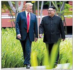  ?? The New York Times/DOUG MILLS ?? President Donald Trump and North Korean leader Kim Jong Un take an after-lunch walk Tuesday on Singapore’s Sentosa Island. Before heading home, Kim said the leaders had “decided to leave the past behind,” adding, “The world will see a major change.”