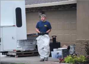  ??  ?? A man with the Federal Bureau of Investigat­ion works at a home on Thursday on Romero Street in Yuba City.