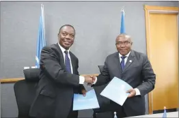  ?? ?? Zambezi Watercours­e Commission executive secretary Felix Ngamlagosi (left) and Food and Agricultur­e Organisati­on sub-regional co-ordinator for southern Africa, Patrice Talla Takoukam shake hands after signing a memorandum of understand­ing