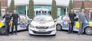  ?? Sunita Gamblin, left, and Clive Grunshaw with officers and the new liveried cars added to Lancashire police’s fleet ??