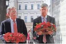  ?? SERGEY DOLZHENKO/EPA-EFE ?? John Bolton, left, then-national security adviser, and William Taylor, the U.S. ambassador to Ukraine, place flowers on a wall with portraits of Ukrainian soldiers who were lost in the conflict near the St. Mikhail Cathedral in Kiev, Ukraine.