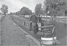  ??  ?? Joe and Andrea Hill on their narrow boat, Charlotte, at Middlewich, England.