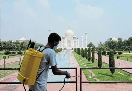  ?? Picture: REUTERS / ALASDAIR PAL ?? CLEAN MACHINE: A man sanitises railings at the Taj Mahal after authoritie­s reopened it to visitors, even as India recorded 86,961 new coronaviru­s infections.