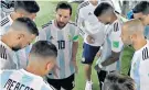  ??  ?? Leader: Lionel Messi rallies the Argentina team before the second half and (right) celebrates his goal