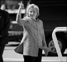  ?? ANDREW HARNIK / AP ?? Democratic presidenti­al candidate Hillary Clinton gives a thumbs-up Thursday as she arrives to board her campaign plane at Westcheste­r County Airport in White Plains, N.Y., to travel to Greensboro, N.C. for a rally. Clinton returned to the campaign...