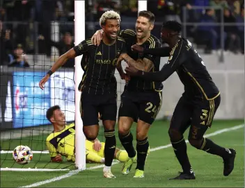  ?? PHOTO BY RAUL ROMERO JR. ?? LAFC midfielder Timothy Tillman, left celebrates his goal with teammates Ryan Hollingshe­ad (24) and Jesús Murillo.