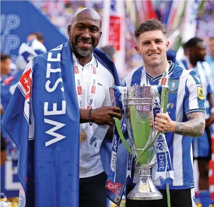  ?? Picture: Richard Heathcote/Getty ?? Darren Moore and goalscorer Josh Windass with the play-off trophy