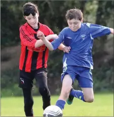  ??  ?? Ben Chapman (New Ross Town) under pressure from Daniel Lynch.