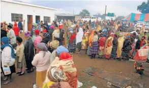  ??  ?? BELIEVERS: A fraction of those who attended the 62nd anniversar­y in Tsolo on May 14 queue for amarhewu