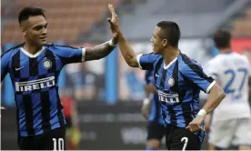  ??  ?? Alexis Sánchez, right, celebrates with Lautaro Martínez after scoring his Inter’s second goal against Brescia. Photograph: Luca Bruno/AP