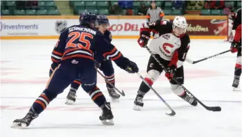  ?? CITIZEN PHOTO BY JAMES DOYLE ?? Prince George Cougars forward Matej Toman attempts a shot on goal while being defended by Quinn Schmiemann of the Kamloops Blazers on Saturday night at CN Centre.