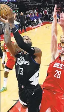  ?? Eric Christian Smith Associated Press ?? THE CLIPPERS’ Paul George, who scored 22 points and sat out the fourth quarter, shoots against the Rockets’ Alperen Sengun.