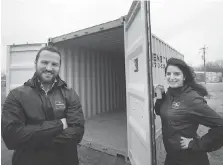  ?? DAX MELMER ?? Go Produce owner Josh Mastronard­i and marketing specialist Amy Saba stand Tuesday with a container they’ll use for a pop-up micro grocery store that will operate from May to October.