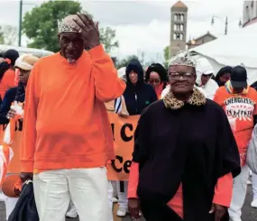  ?? BRAD VEST/THE COMMERCIAL APPEAL ?? Preston Hurt, left, and W. Estelle Taylor, right, march as king and queen of the Orange Mound Senior Center during the Africa in April Internatio­nal Diversity Parade on April 19, 2019. The 2021 Africa in April Cultural Awareness Festival will be Aug. 5-8.