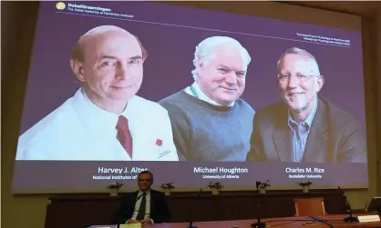  ?? Photograph: Jonathan Nackstrand/AFP/Getty Images ?? Nobel committee member Patrik Ernfors sits in front of a screen displaying the winners, (from left) Harvey Alter, Michael Houghton and Charles Rice, at the Karolinska Institute in Stockholm, Sweden, on Monday.