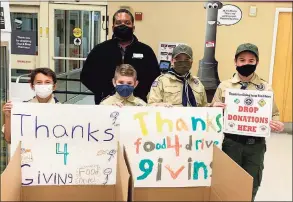  ?? Contribute­d photo ?? Scouts Benjamin Allen, Ryan Berendt, Zachary Shoop and Jason Zurow with Stop & Shop store manager Carl Henry on Tuesday. The Scouts were collecting food for the Thanks-4-Giving campaign.