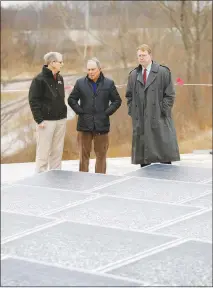  ?? CHARLIE NEIBERGALL / AP ?? Former New York Mayor Michael Bloomberg, center, looks at solar panels with former Paulson Electric Company president Ron Olson, left, and Iowa State Sen. Rob Hogg, D-cedar Rapids, right, Tuesday in Cedar Rapids, Iowa.