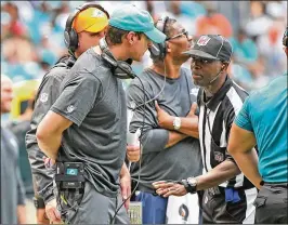  ?? CHARLES TRAINOR JR. / MIAMI HERALD ?? Dolphins coach Adam Gase (left) has helped quarterbac­k Ryan Tannehill become a more effective passer.