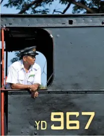  ??  ?? Immaculate­ly dressed. Myanmar Railways’ steam locomotive drivers always wear white shirts or jackets. They simply drive and instruct the locomotive crews where to oil.