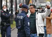  ?? Joe Klamar / AFP via Getty Images ?? A protester with the National Council of Resistance of Iran yells at a police officer in Vienna near where negotiator­s are discussing Iran’s nuclear deal.