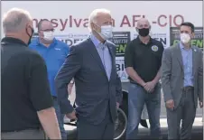  ?? CAROLYN KASTER — THE ASSOCIATED PRESS ?? Democratic presidenti­al candidate former Vice President Joe Biden talks with union leaders after taking photograph­s outside the AFL-CIO headquarte­rs in Harrisburg, Monday, Sept. 7, 2020.