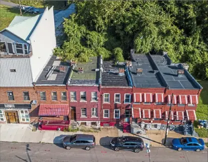  ?? Andrew Rush/Post-Gazette ?? A row of houses Aug. 8 in the 2300 block of Centre Avenue in the Hill District, where a dilapidate­d city-owned home has become a problem for the neighbors.