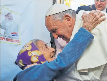  ??  ?? WELCOME: Pope Francis is greeted by one of the faithful during his visit to the Banado Norte shanty town in Asuncion, Paraguay.