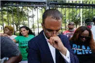  ?? The Associated Press ?? ■ Mona Hardin, background left in green, mother of Ronald Greene, prays outside the gates of the governor’s mansion in Baton Rouge, La., on May 27, 2021, while protesting her son’s death. Greene died in the custody of Louisiana State Police in 2019. Ron Haley, attorney for the Greene family, foreground, has been hired by the family of Alonzo Bagley, a man fatally shot by police in Shreveport, La., on Feb. 3. The head of Louisiana State Police is calling for patience as detectives look into the death of Bagley.